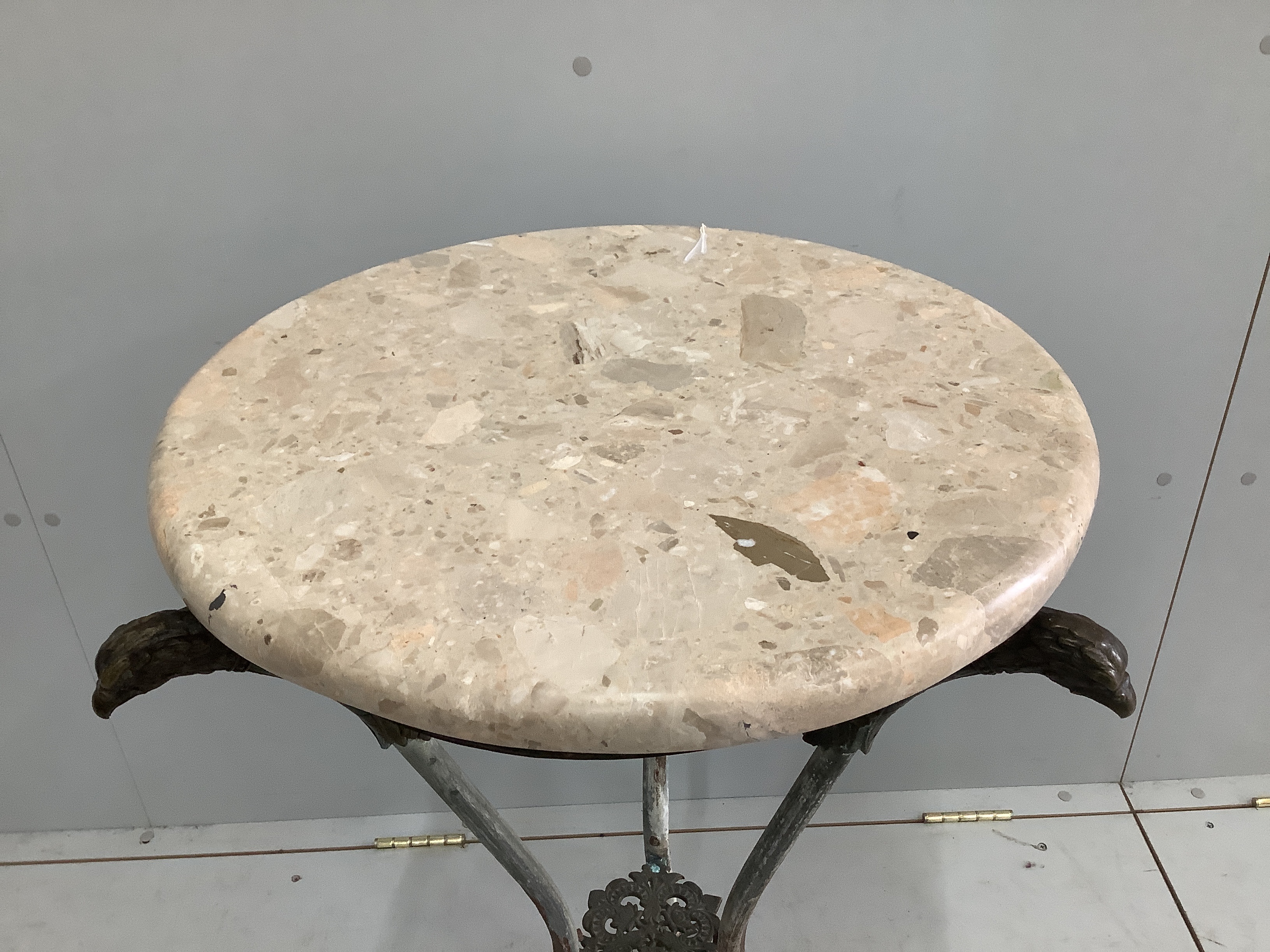 An Empire style circular cast metal, marble top occasional table with eagle head supports, diameter 53cm, height 80cm
